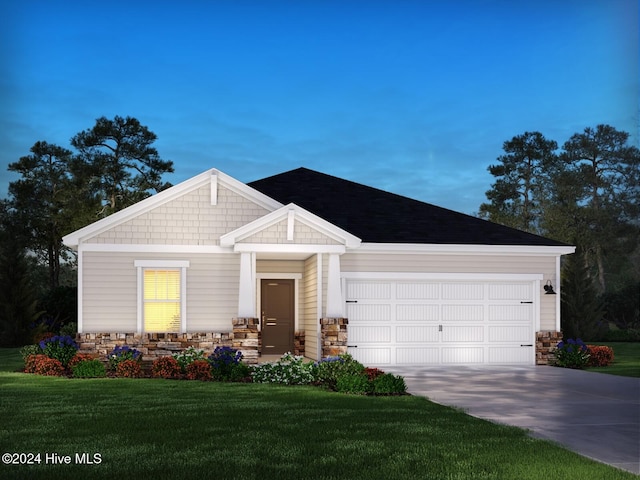 view of front of house with a yard and a garage