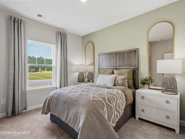 bedroom featuring light carpet