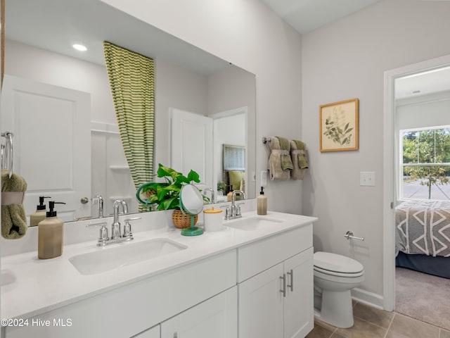 bathroom with tile patterned floors, vanity, and toilet