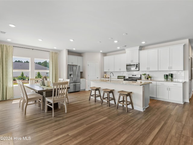 kitchen with white cabinets, dark wood-type flooring, and appliances with stainless steel finishes