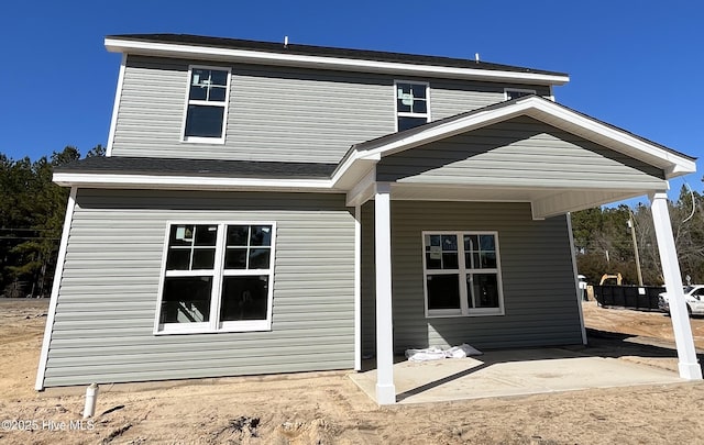 back of property with a patio