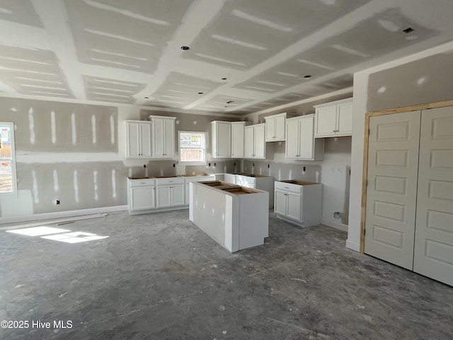 kitchen with white cabinetry and a kitchen island