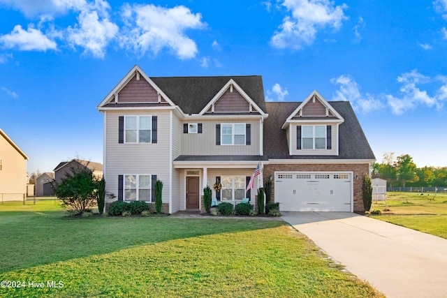 craftsman inspired home with a front yard and a garage