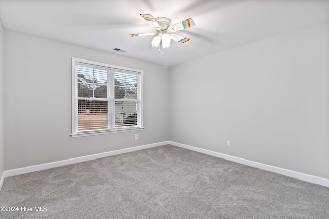 carpeted empty room featuring ceiling fan