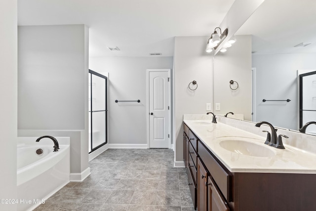 bathroom featuring vanity and separate shower and tub