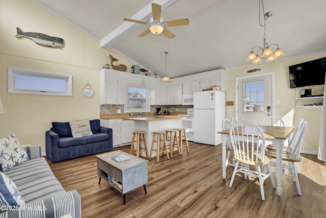 living room with high vaulted ceiling, beamed ceiling, sink, ceiling fan, and light hardwood / wood-style floors