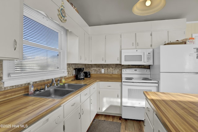 kitchen with wood-type flooring, sink, white cabinets, decorative backsplash, and white appliances