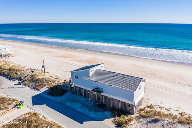 bird's eye view featuring a water view and a beach view