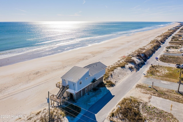 aerial view with a water view and a beach view