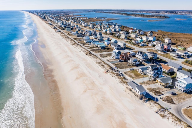 birds eye view of property featuring a view of the beach and a water view