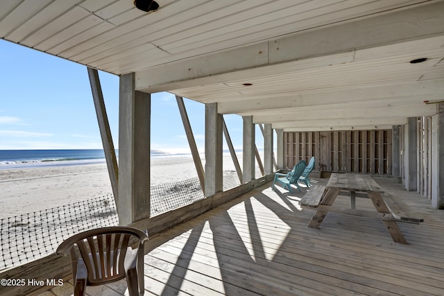 wooden terrace with a water view and a beach view