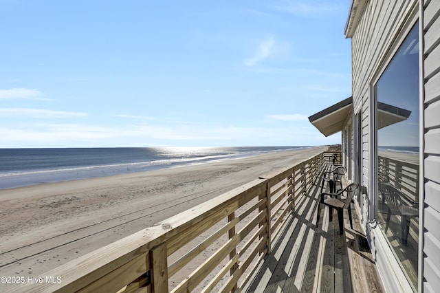 view of home's community featuring a water view and a view of the beach