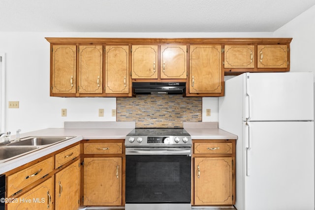 kitchen with electric range, white fridge, dishwashing machine, sink, and backsplash