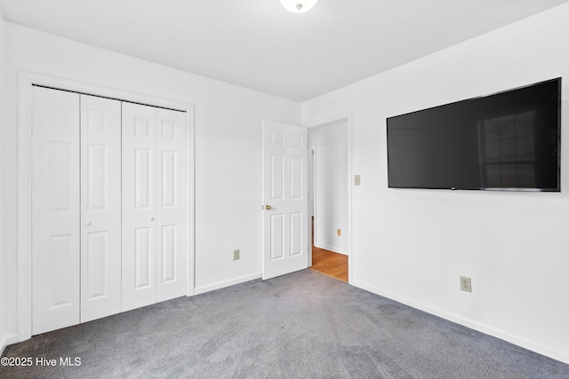 unfurnished bedroom featuring a closet and carpet