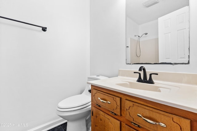 bathroom featuring toilet, a shower, and vanity