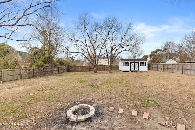 view of yard with a fire pit and a storage shed