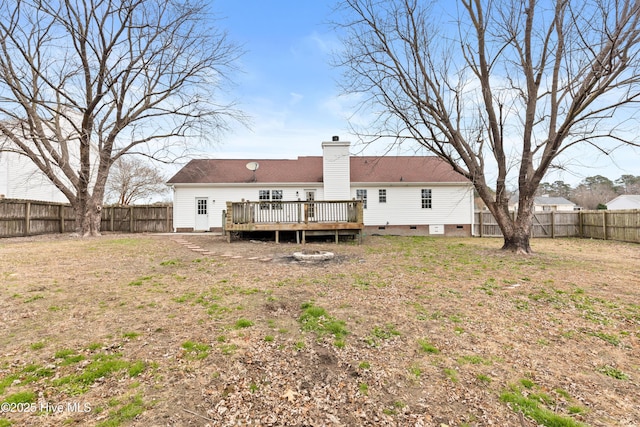 rear view of property featuring a yard and a deck