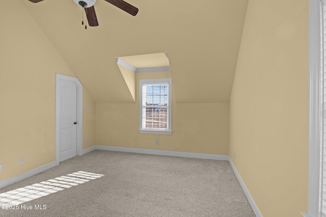 bonus room with ceiling fan, light colored carpet, and vaulted ceiling