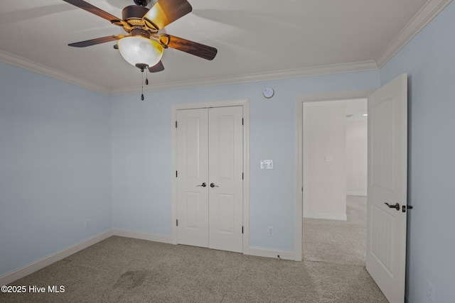 unfurnished bedroom with ceiling fan, crown molding, a closet, and light carpet