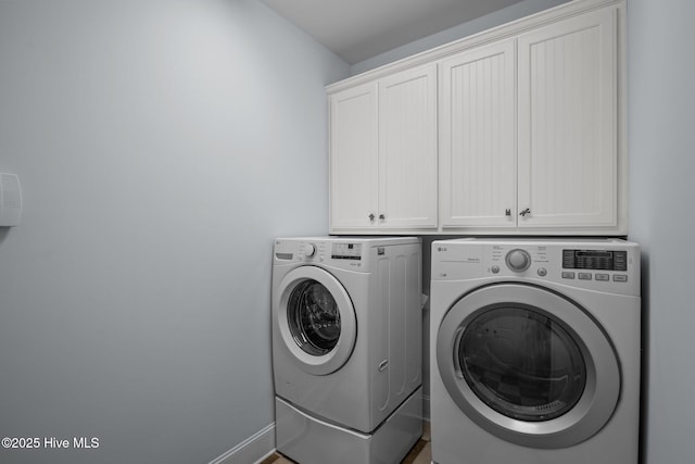 laundry room with cabinets and independent washer and dryer