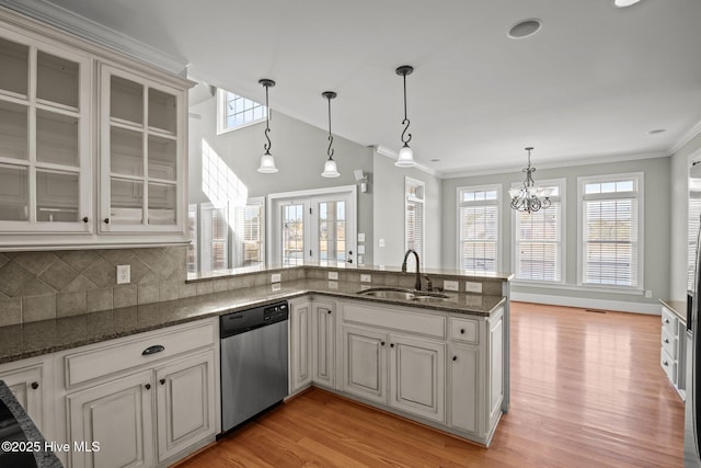 kitchen with dishwasher, decorative light fixtures, white cabinetry, sink, and backsplash