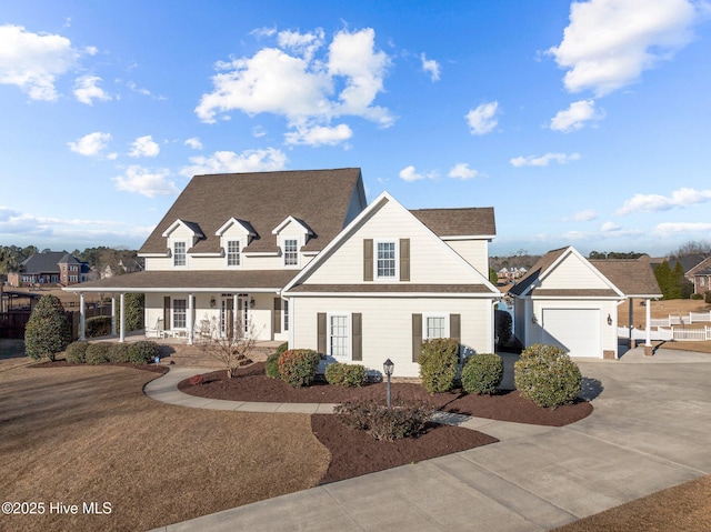 view of front of property featuring covered porch and a garage