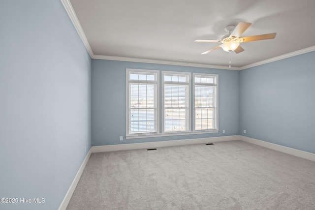 spare room featuring ceiling fan, ornamental molding, and carpet flooring