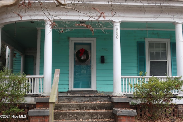 view of exterior entry with a porch