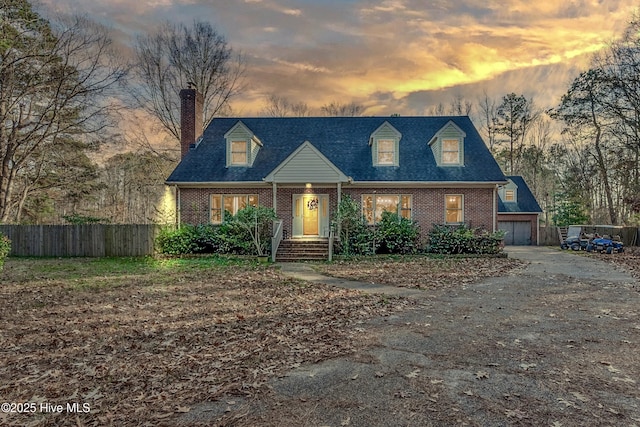 new england style home featuring a garage