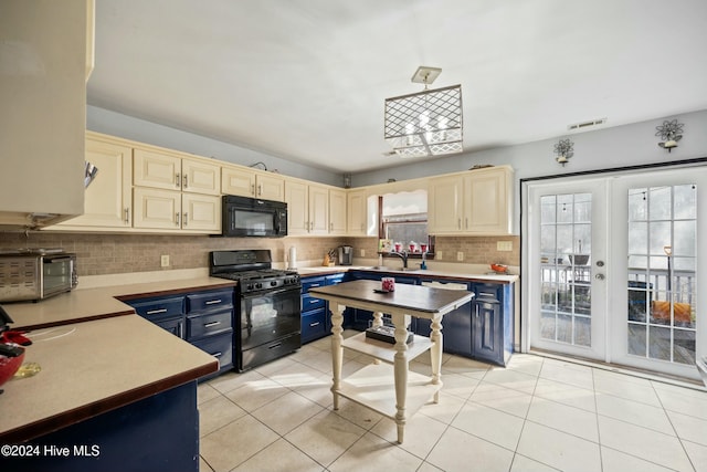 kitchen with blue cabinetry, black appliances, light tile patterned floors, cream cabinets, and backsplash