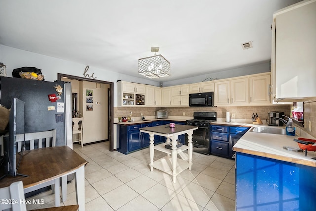 kitchen with sink, blue cabinets, black appliances, light tile patterned flooring, and decorative light fixtures