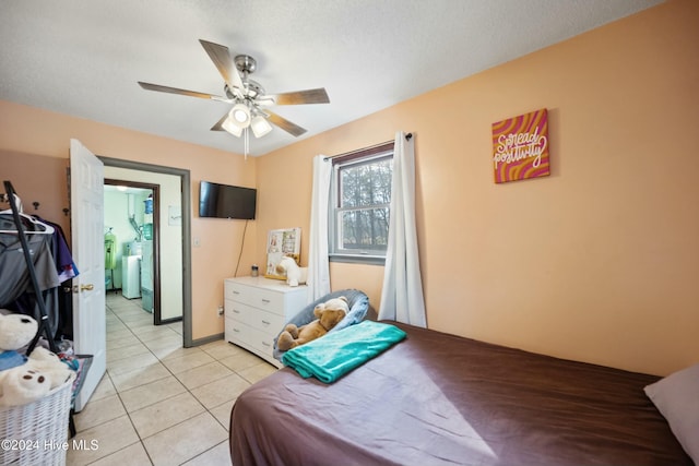 tiled bedroom featuring washer and clothes dryer, a textured ceiling, and ceiling fan