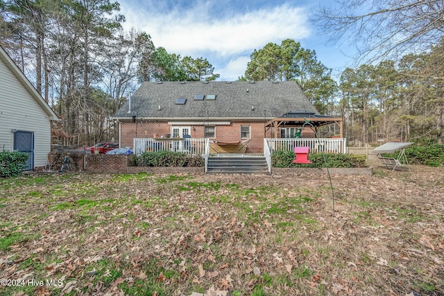 back of property with a gazebo and a deck