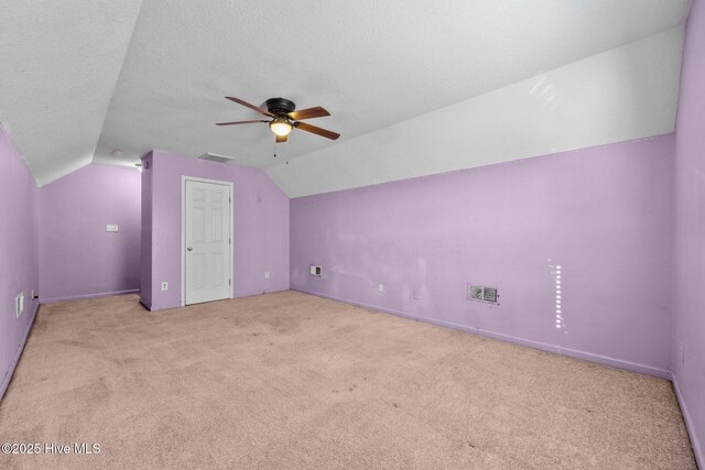 washroom with washing machine and dryer, a textured ceiling, and cabinets