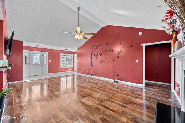 bonus room featuring ceiling fan, vaulted ceiling, light carpet, and a textured ceiling