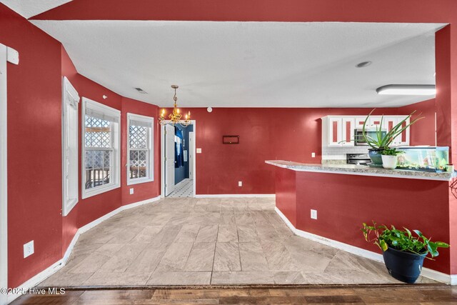 tiled living room featuring ceiling fan and vaulted ceiling