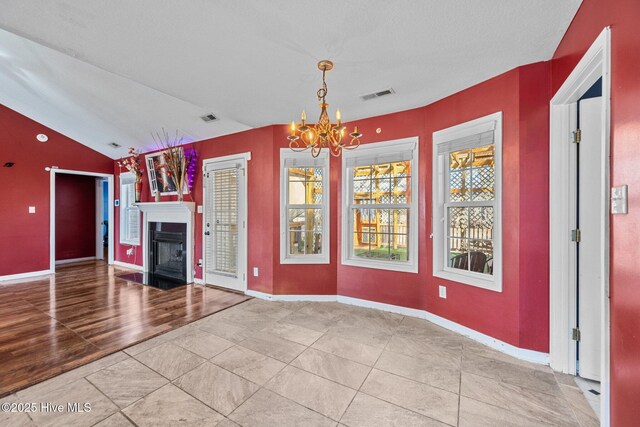 unfurnished living room with lofted ceiling, wood-type flooring, and ceiling fan