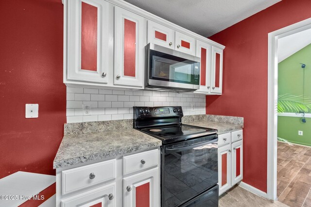 unfurnished living room with lofted ceiling, tile patterned flooring, and a notable chandelier