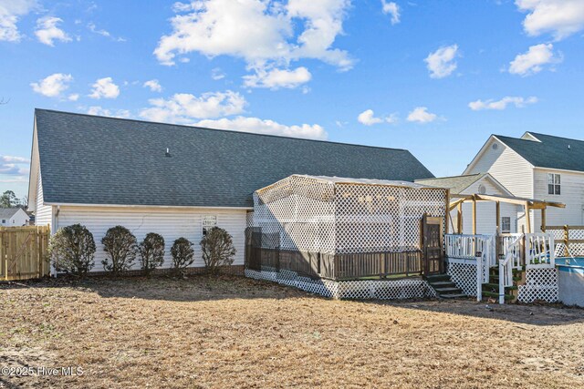 ranch-style home with a porch, a front lawn, and a garage