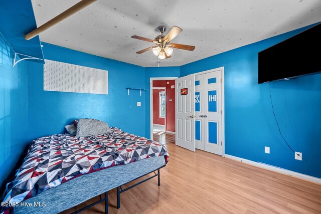 bedroom with ceiling fan and hardwood / wood-style floors