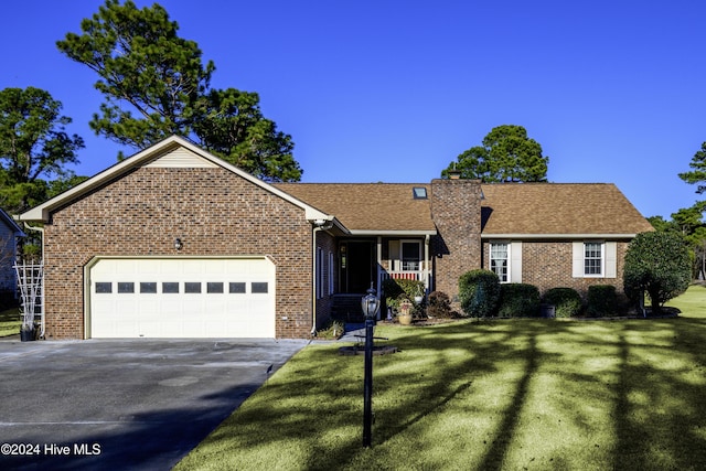 single story home featuring a garage and a front yard