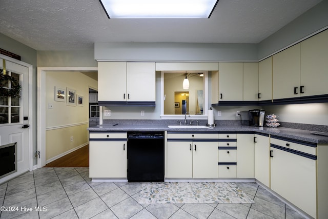 kitchen featuring white cabinets, sink, light tile patterned floors, a textured ceiling, and black dishwasher