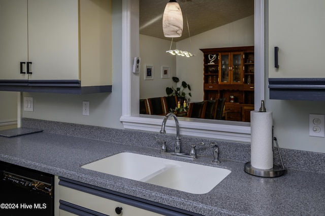 kitchen featuring dishwasher, decorative light fixtures, lofted ceiling, and sink