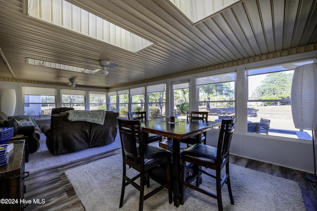 sunroom / solarium with a skylight, ceiling fan, and a wealth of natural light