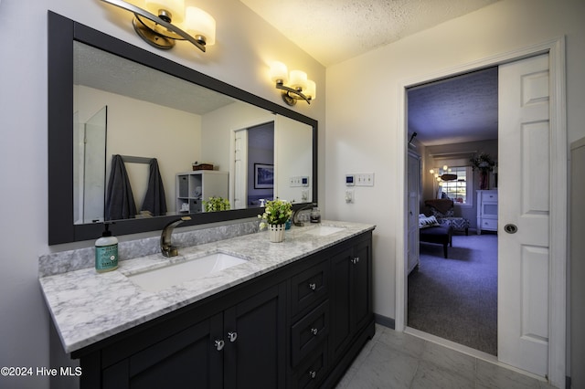 bathroom featuring vanity and a textured ceiling