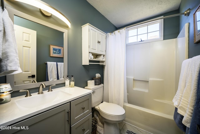 full bathroom with shower / bath combination with curtain, toilet, a textured ceiling, and vanity