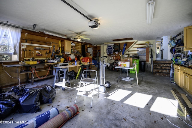 garage with a workshop area, ceiling fan, and a garage door opener