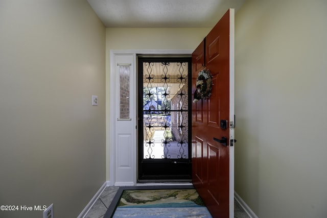 doorway with tile patterned flooring