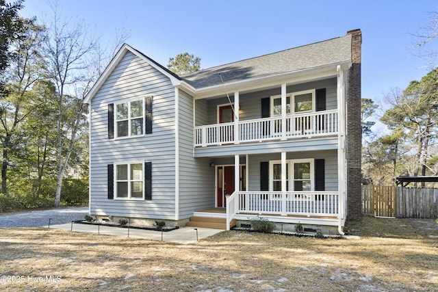 view of front of house with covered porch and a balcony