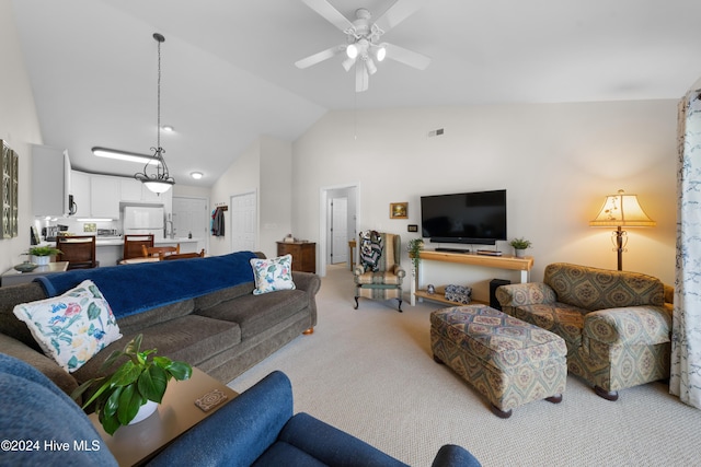 carpeted living room featuring ceiling fan and vaulted ceiling